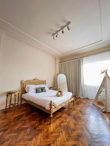 a bedroom with a bed with a wooden floor and a window at El Otel Hotel in Cairo