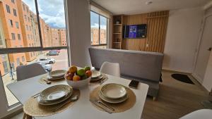 a white table with a bowl of fruit on it at Apartamento Urban Paipa in Paipa +19 photos