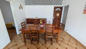 a dining room with a wooden table and chairs at La Casa Créole, spa, 3 ch, 2 sdb, centre de la Guadeloupe in Les Abymes +22 photos