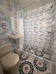 a bathroom with a toilet and a sink at Hotel Hostal Urban18 in Bogotá