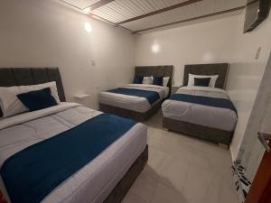 a bedroom with two beds in a room at Hotel Hostal Urban18 in Bogotá