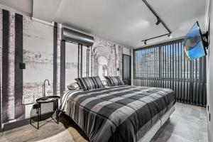 a bedroom with a bed and a large window at Design Tech Comfort & Location in Santiago +94 photos