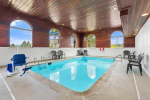 a swimming pool in a house with a wooden ceiling at Quality Inn Sheridan in Sheridan