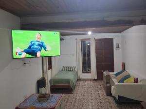 a living room with a flat screen tv on the wall at CASA ANTONIA in Embalse