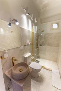 a bathroom with a toilet and a sink and a shower at El Otel Hotel in Cairo