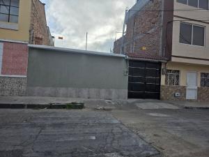 an empty parking lot next to a building with a garage at Verona house in Riobamba