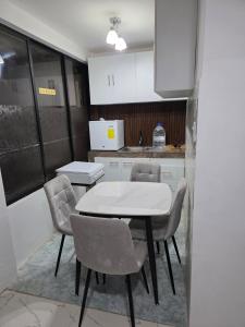 a kitchen with a table and chairs in a room at Verona house in Riobamba