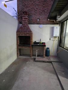 a brick fireplace in a room with a table at Verona house in Riobamba +3 photos