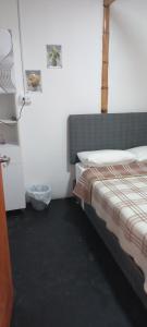 a bedroom with a bed and a refrigerator at casa posada paracas in Paracas