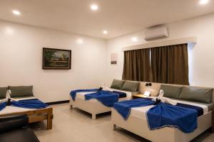 a room with two beds and a couch at Casa Blanca Tanay in Tanay