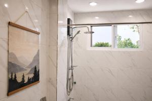 a shower stall in a bathroom with a window at Casa Blanca Tanay in Tanay