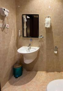 a bathroom with a sink and a mirror and a toilet at شقق السعادة سويت للشقق المخدومة - Saada Suites Serviced Apartments in Riyadh +61 photos
