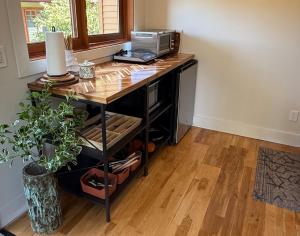 a room with a desk with a printer on it at Artisan Suites on Bowen in Bowen Island