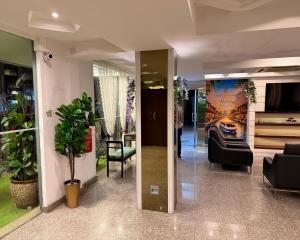 a lobby with a couch and a poster on the wall at Royal Queenspark Hotel in Malacca +36 photos