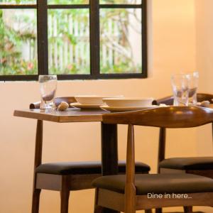 a wooden table with chairs and glasses on it at Casa Blanca Tanay in Tanay