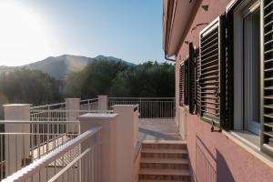 a balcony of a house with stairs and a window at Fili d'Erba Cilento in Villammare