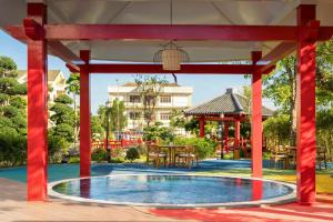 a pavilion with a pool in the middle of a yard at TUI BLUE Tuy Hoa - Wellness & Retreat Hotel in Tuy Hoa