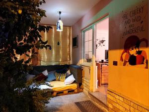 a living room with a couch and a tree at Villa Villekulla in Tirana