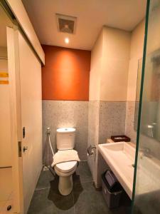 a bathroom with a toilet and a sink at Marra Hotel in Yogyakarta +79 photos