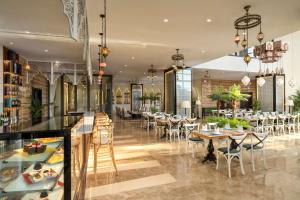 a restaurant with tables and chairs in a room at TUI BLUE Tuy Hoa - Wellness & Retreat Hotel in Tuy Hoa