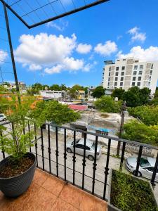 a balcony with a view of a parking lot at Aguacatl Cozumel a 3 cuadras del mar in Cozumel