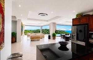 a kitchen and living room with a view of the ocean at Casa Nicola Amazing Sea View Villa in Koh Samui in Nathon Bay