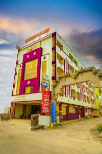 a large building with a colorful building at Park Palace Inn in Erode