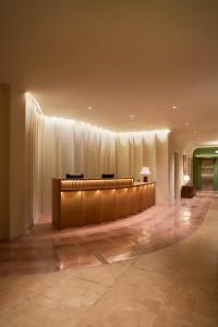a lobby with a long desk in a building at Len Hotel in Da Lat