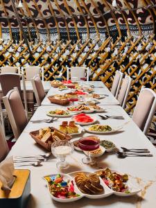 a long table with plates of food on it at Son-Köl Glamping in Song-Kul