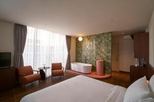 a hotel room with a bed and a bath tub at Len Hotel in Da Lat +67 photos