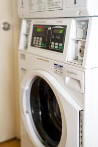 a white washer and dryer in a room at Caboolture Gateway Motel in Caboolture