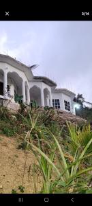 a large white house on top of a hill at O-t on the rise in Tweedside