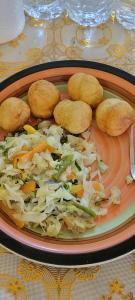 a plate of food with cabbage and vegetables on a table at O-t on the rise in Tweedside