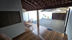a large room with a wooden floor and a stage at Casa aconchegante A , 4 minutos do thermas in Andradina