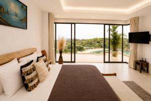 a bedroom with a bed and a view of a pool at Casa Nicola Amazing Sea View Villa in Koh Samui in Nathon Bay +110 photos
