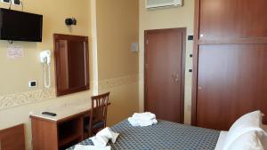 Postel nebo postele na pokoji v ubytování Hotel Grifone