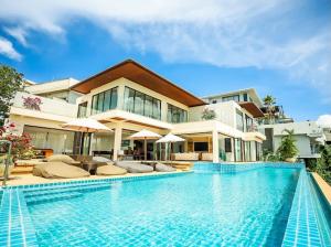 a house with a swimming pool in front of a building at Casa Nicola Amazing Sea View Villa in Koh Samui in Nathon Bay
