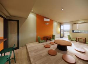 a room with a table and some chairs and a table at Rebel Rooster Hostel in Hanoi