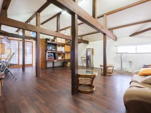 a living room with a couch and a table at Minshuku Meiwaso in Takaoka