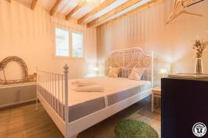 a bedroom with a white bed in a room at La busquette in Villaudric +23 photos