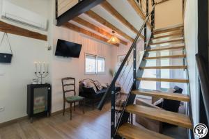 a staircase in a room with a table and a chair at La busquette in Villaudric