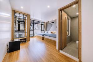 a living room with a bed and a tv in a room at Minn Cat Ba in Cat Ba