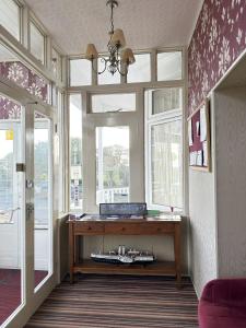 a room with a wooden table in front of a window at SmartsWay Hotel & Wellness in Eastbourne