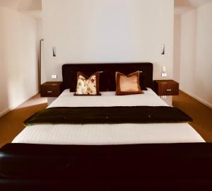 a bedroom with a large bed with pillows on it at The Siding Yallingup in Yallingup