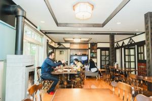 two people sitting at a table in a restaurant at ラリックス蓼科 in Chino