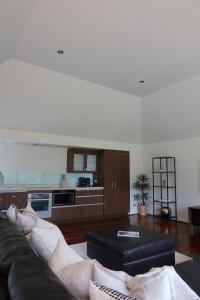 a living room with a couch and a kitchen at The Siding Yallingup in Yallingup +7 photos