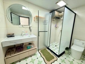 a bathroom with a shower and a sink and a toilet at Gubeikou Great Wall Yunyeshu Boutique Guesthome in Miyun +57 photos