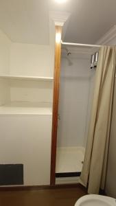 a bathroom with a shower with a curtain and a toilet at Las Cinco Esquinas in Nueve de Julio
