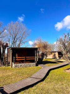 a walkway leading to a building in a park at Las Cinco Esquinas in Nueve de Julio +14 photos
