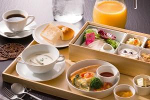 a tray with a tray of food and a cup of coffee at HOTEL BEACON ONOMICHI in Onomichi